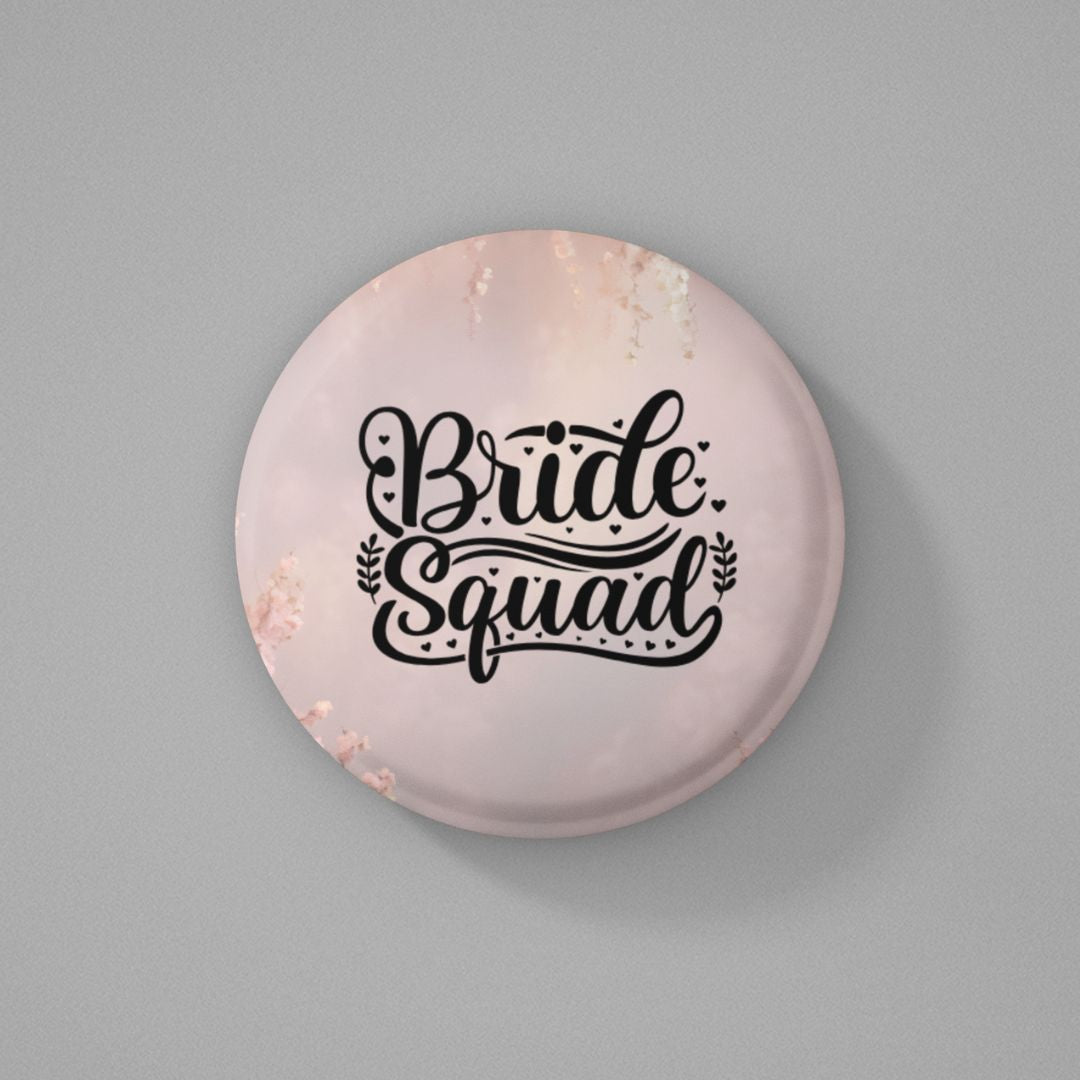 Round pink color button badge with 'Bride Squad' text on a gray background