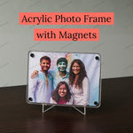 Acrylic photo frame with magnets displaying a family photo on a dark surface.