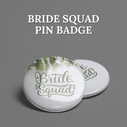 Two 'Bride Squad' pin badges placed on a gray background with text written above them.