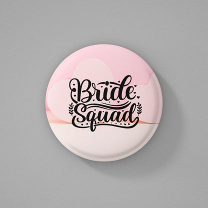 Button badge with 'Bride Squad' text on a pink and white gradient background