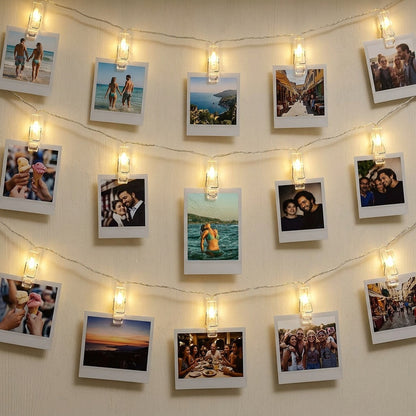 LED String lights with polaroid photos displaying various images on a wall.