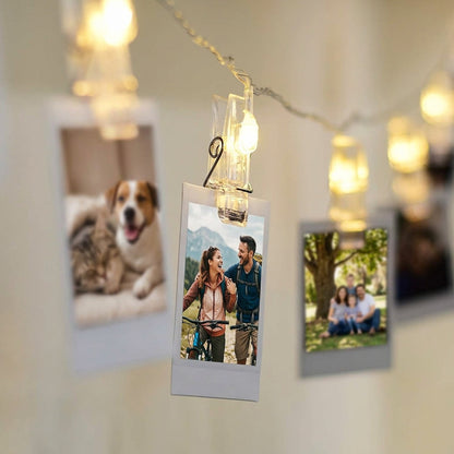 LED String lights with clips and polaroid photo prints hanging on a wall for decor