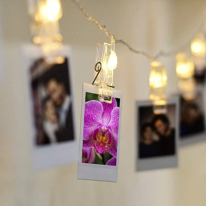 LED String lights with clips and polaroid photo prints hanging on a wall for room decor