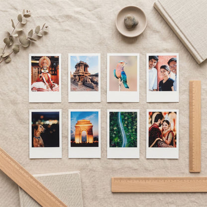 Collection of polaroid photo prints on a textured surface with decorative elements.