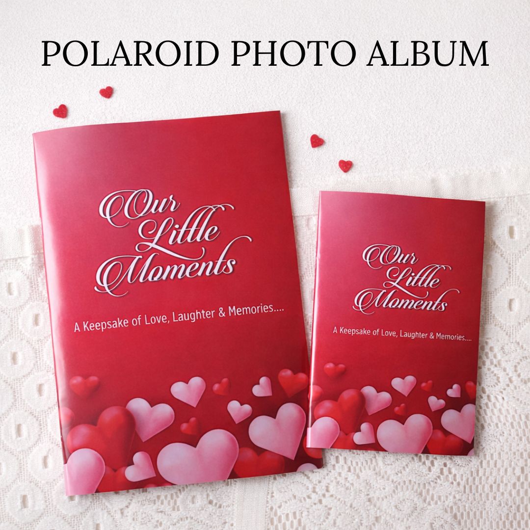 Red colored Polaroid photo album with 'Our Little Moments' text and heart designs on a white lace background.