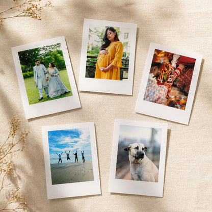 Collection of Polaroid photo prints on a textured surface with dried plants.