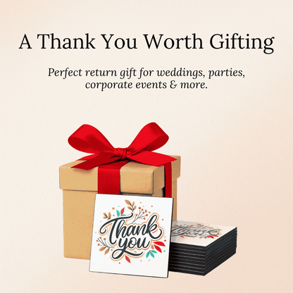 Gift box with red ribbon, 'Thank you' fridge magnets on a beige background
